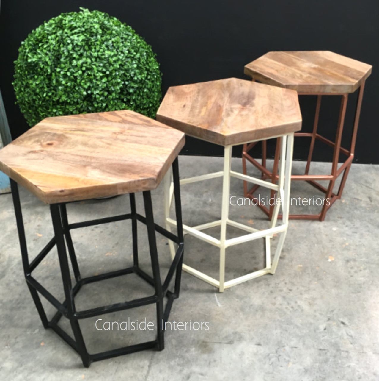 Sleek and modern Hex Stool in distressed copper, adding an industrial edge and a warm wooden touch to coastal living room settings - Canalside Interiors