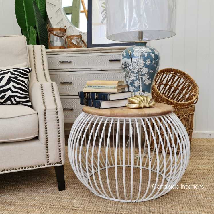 Styled within a living room setting, demonstrating how the table complements both modern and coastal decors.