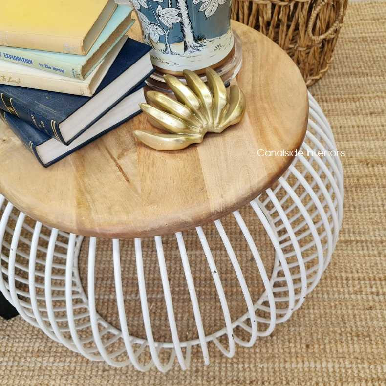 Close-up on the table's distressed white finish, showcasing the texture that adds rustic charm.