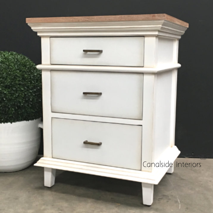 An atmospheric shot in dim lighting, highlighting the warm, inviting ambiance the bedside brings to a room.