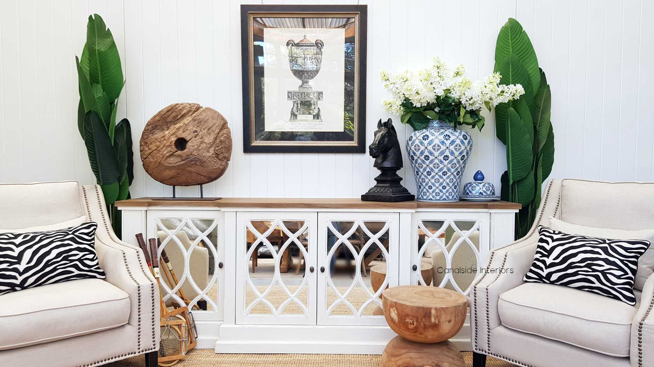 Decor vignette atop the Marielle Mirrored Sideboard, illustrating how its surface can be adorned with decorative items and personal treasures.
