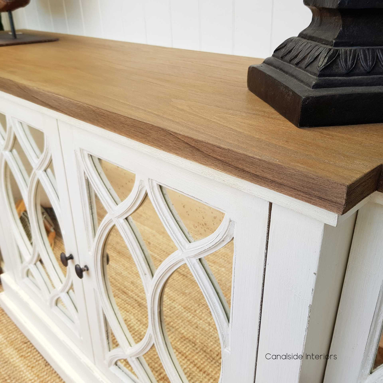 Close-up detail of the Marielle Sideboard's aged-mirrored doors, highlighting the intricate circular overlay pattern and the antique charm it brings to interiors.