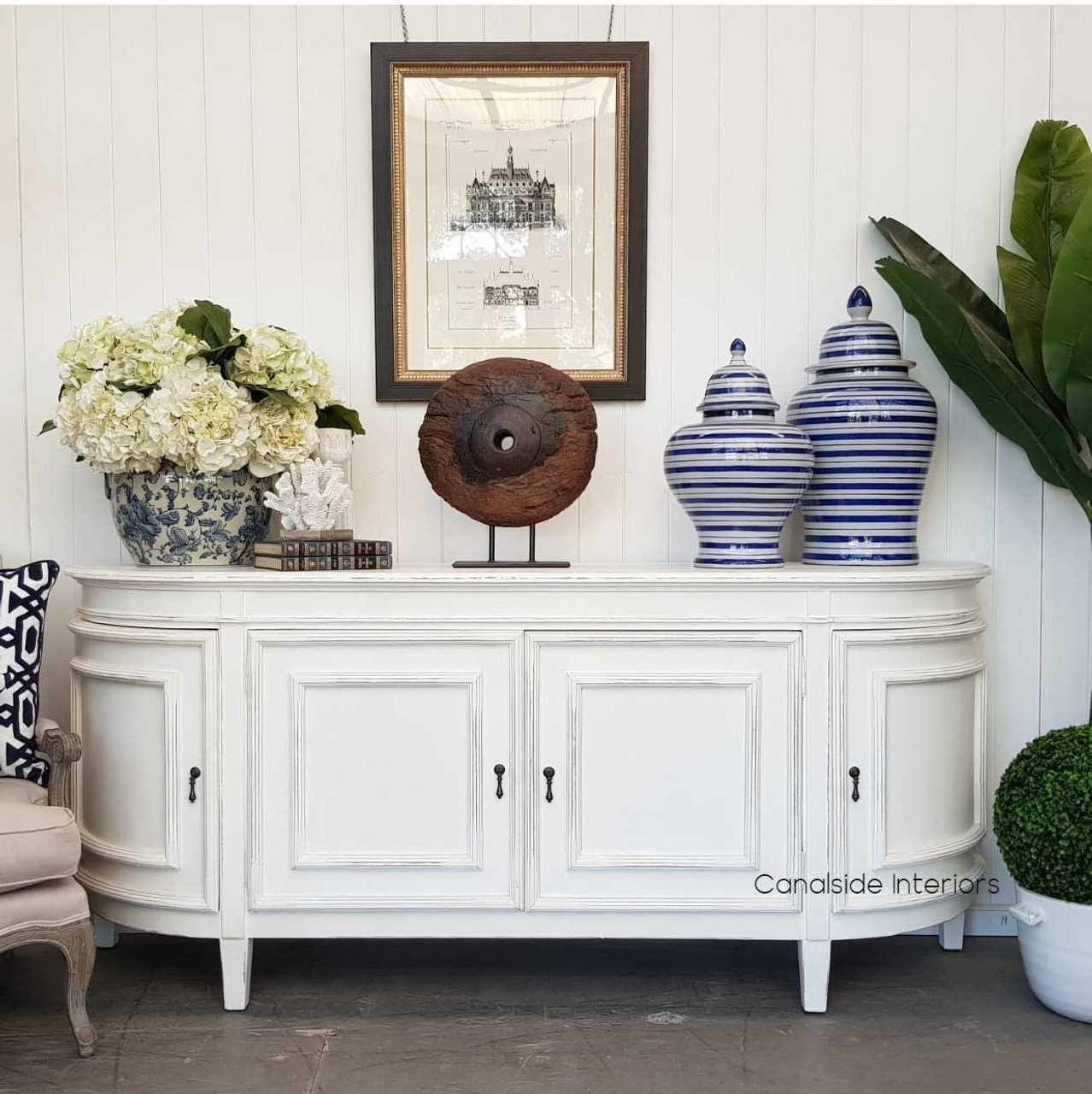 Experience timeless charm with Canalside Interiors' Francia Sideboard in distressed off white, perfect for adding an air of Hamptons elegance to your bedroom