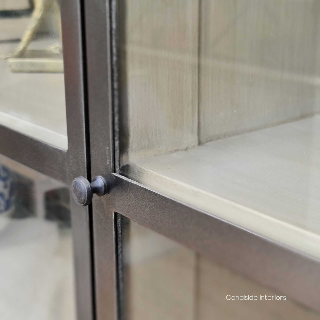 Close-up on the unit's stone interior, showcasing the contrast against the distressed charcoal exterior and the sophisticated space for display.