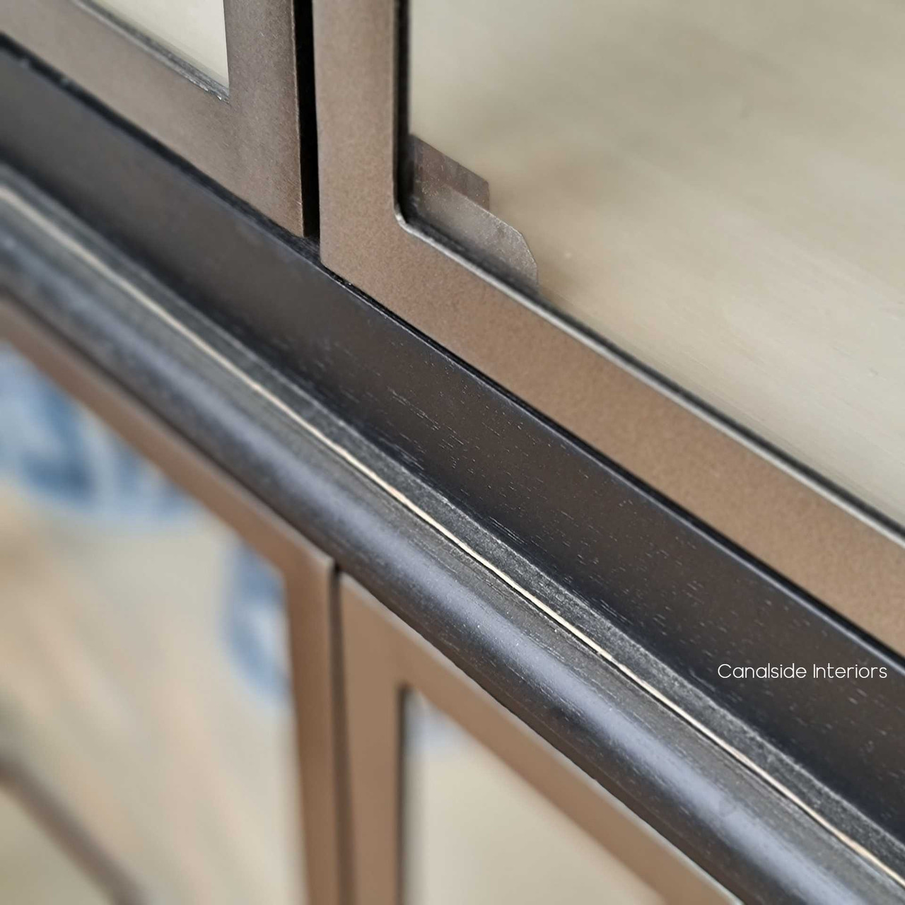 Detail shot of the metal doors, reflecting the meticulous craftsmanship and unique design that adds a modern twist to the piece.