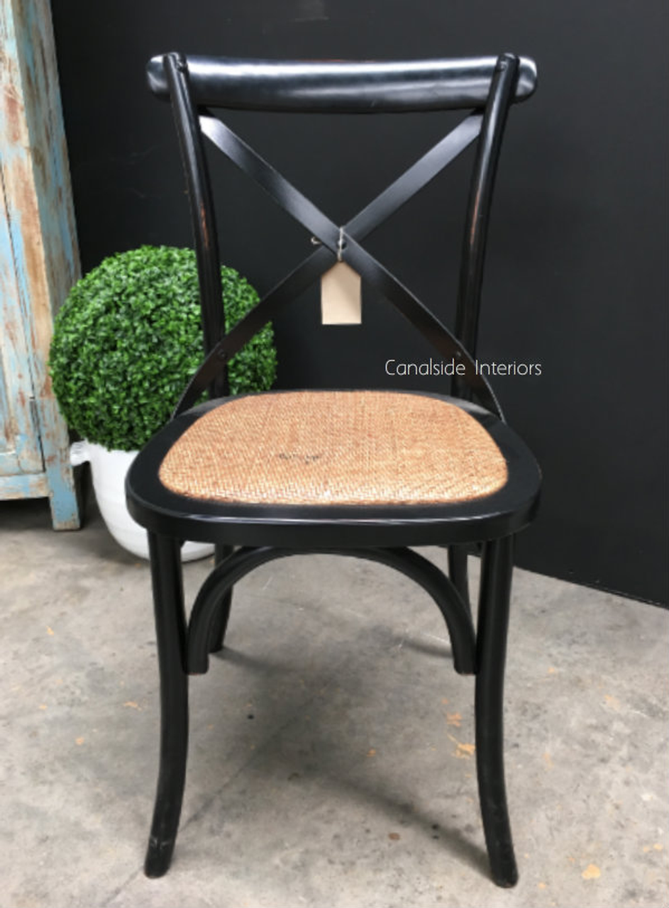 The Canalside Interiors' Cross Back Chair, seen from a three-quarter angle, exudes a modern Hamptons vibe, suitable for any dining room or casual seating area