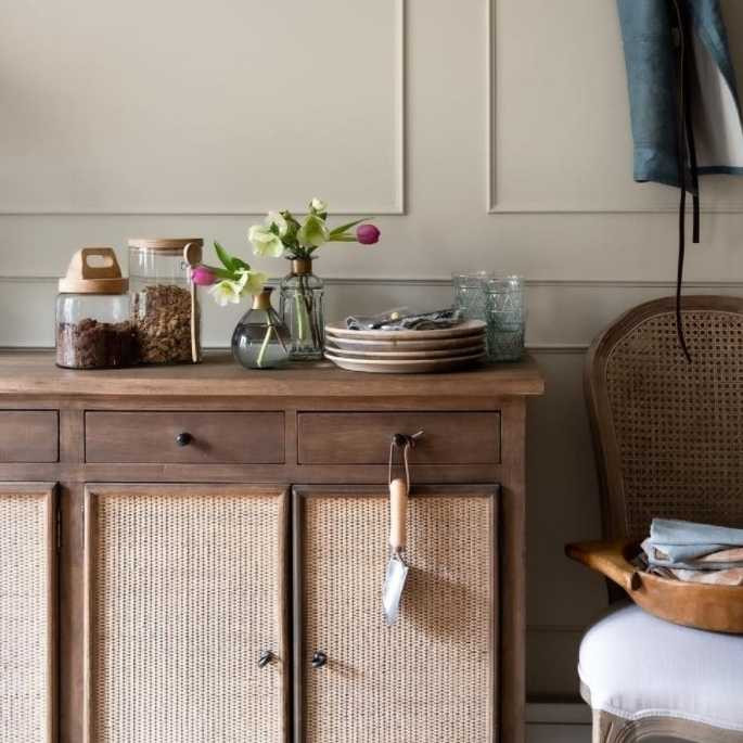 Close-up of the intricate rattan door detail, highlighting the craftsmanship and tropical inspiration behind the sideboard's design.