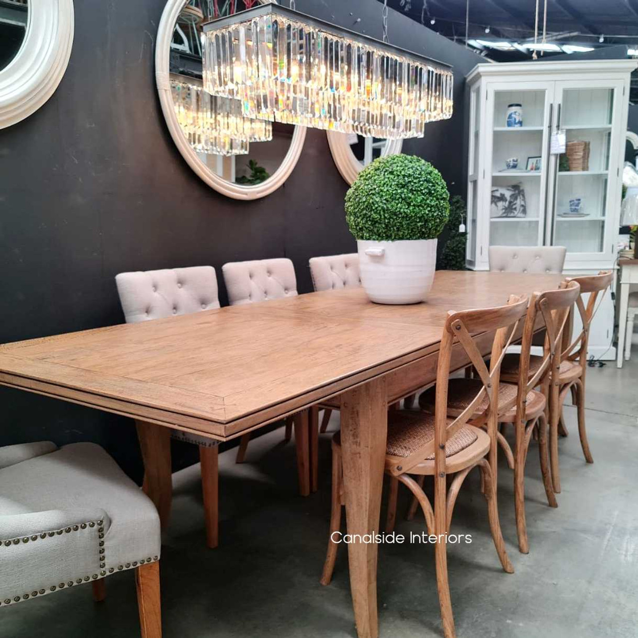 A fusion of Hamptons elegance and rustic charm in this Lavinia Double Extension Dining Table, perfect for transforming dining spaces with its natural wood finish and hand-carved details.