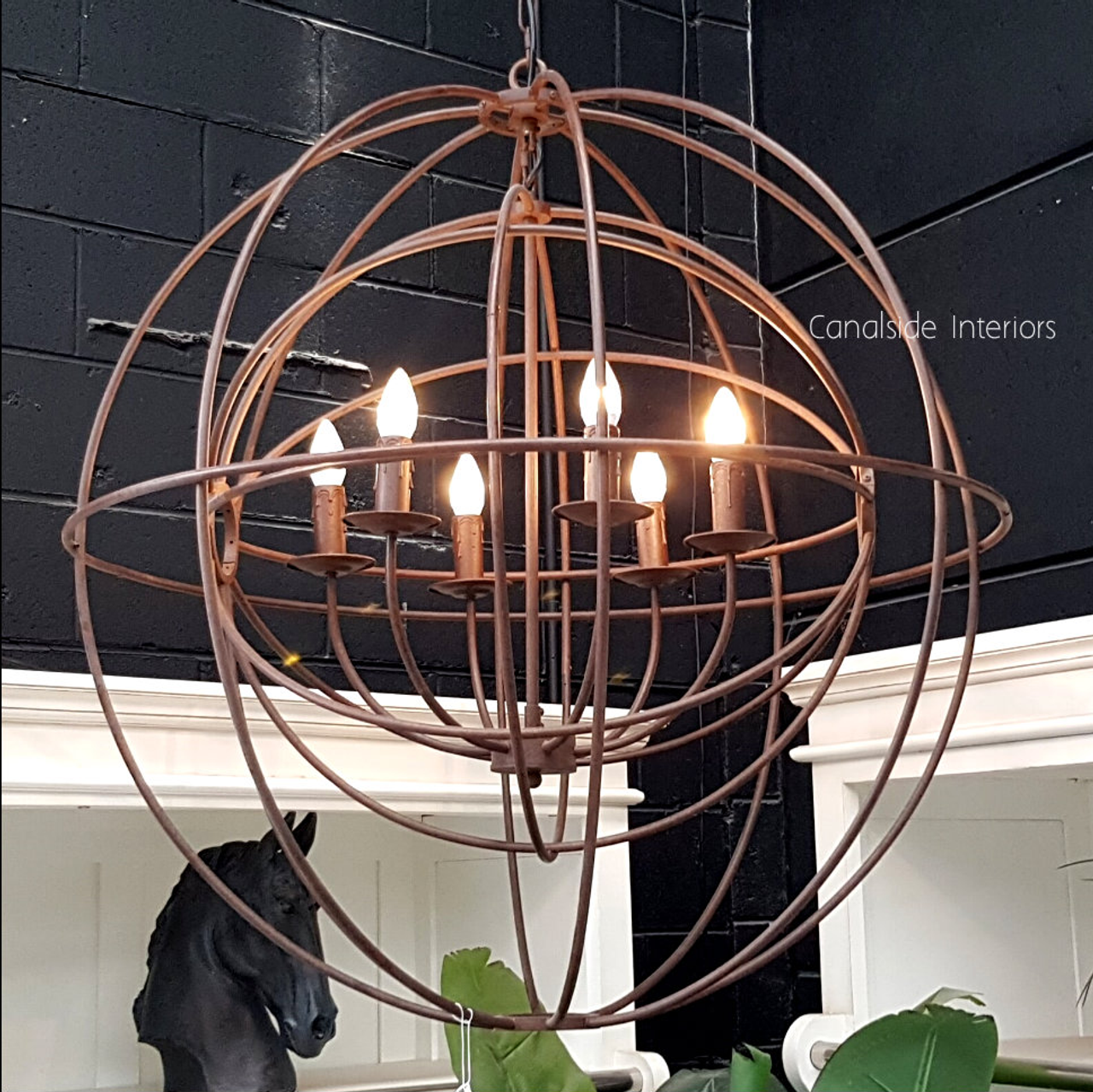Canalside Interiors’ Foucault Twin Orb Chandelier in rust colour, featuring handcrafted bronze-finished metal, ideal for adding a classical touch to your Hamptons-style bedroom