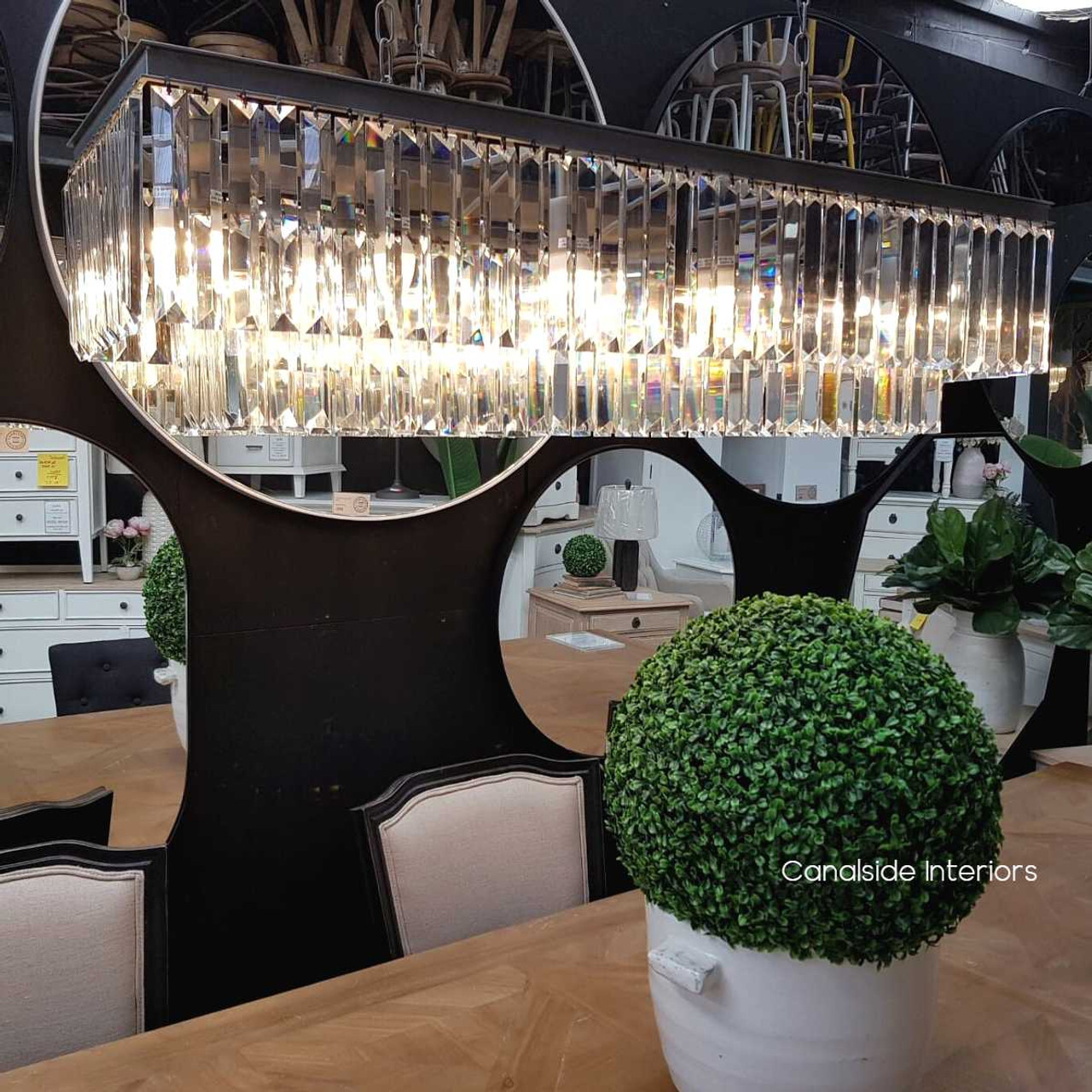 Art Deco-inspired Odeon Rectangular Chandelier casts a shimmering light over a Canalside Interiors-styled modern dining room.