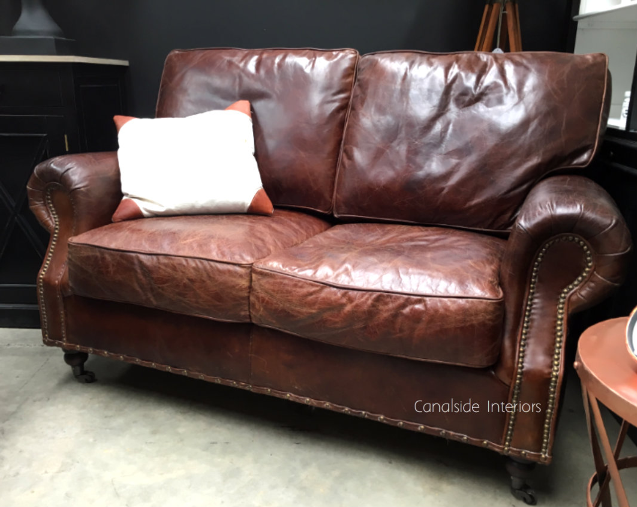 Canalside Interiors presents the Sir William Lounge, where aged leather meets modern sophistication for a truly classic living room centerpiece