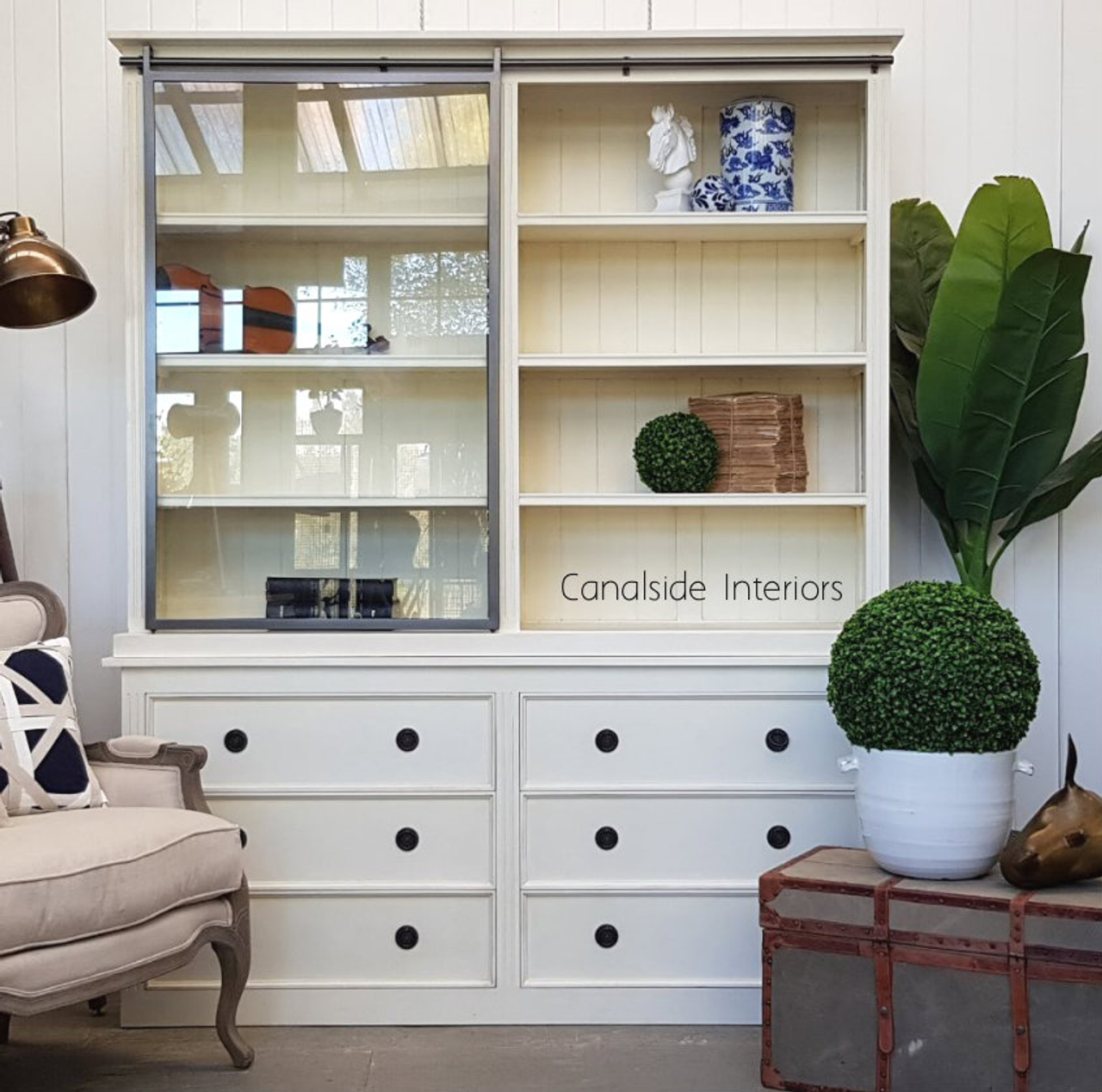 The unit's open shelving section adorned with books and decor, showcasing its versatility and appeal.