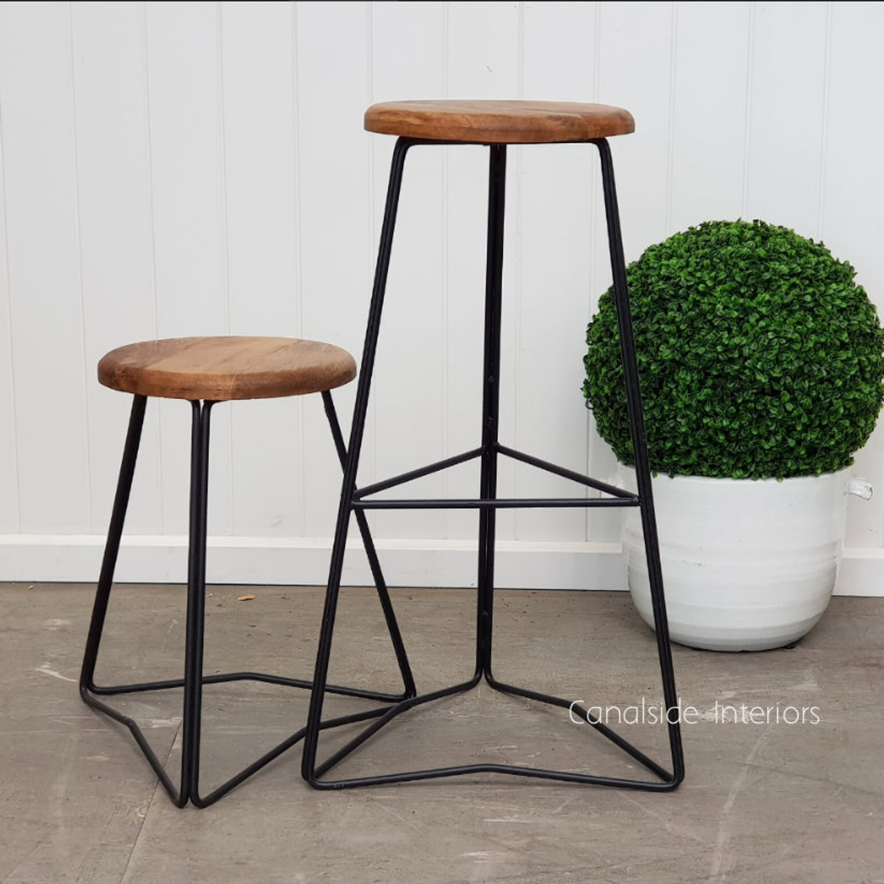 Angled view of the Pippa Low Stool, emphasizing its sleek lines and modern appeal in a coastal living space.