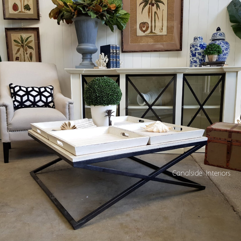 The table adorned with chic decorative items, demonstrating its capacity as both a statement piece and a functional serving table.