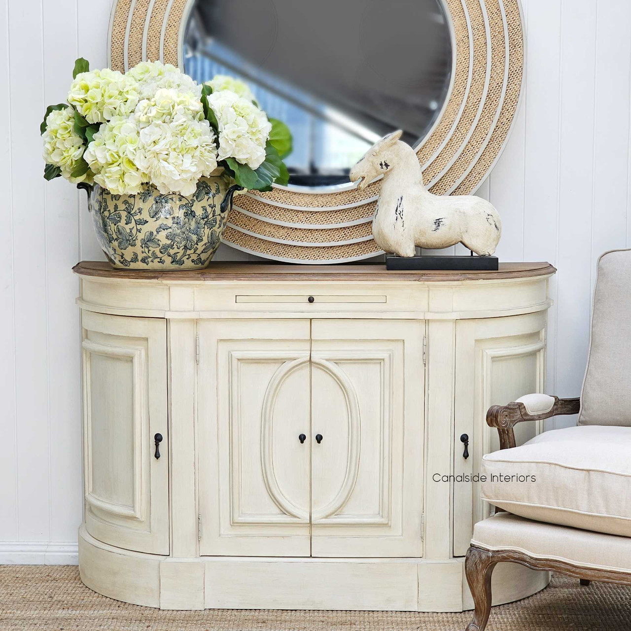 Positioned by the entryway, the Bastian Sideboard serves as both a warm welcome and a stylish storage piece, true to the Hamptons aesthetic.
