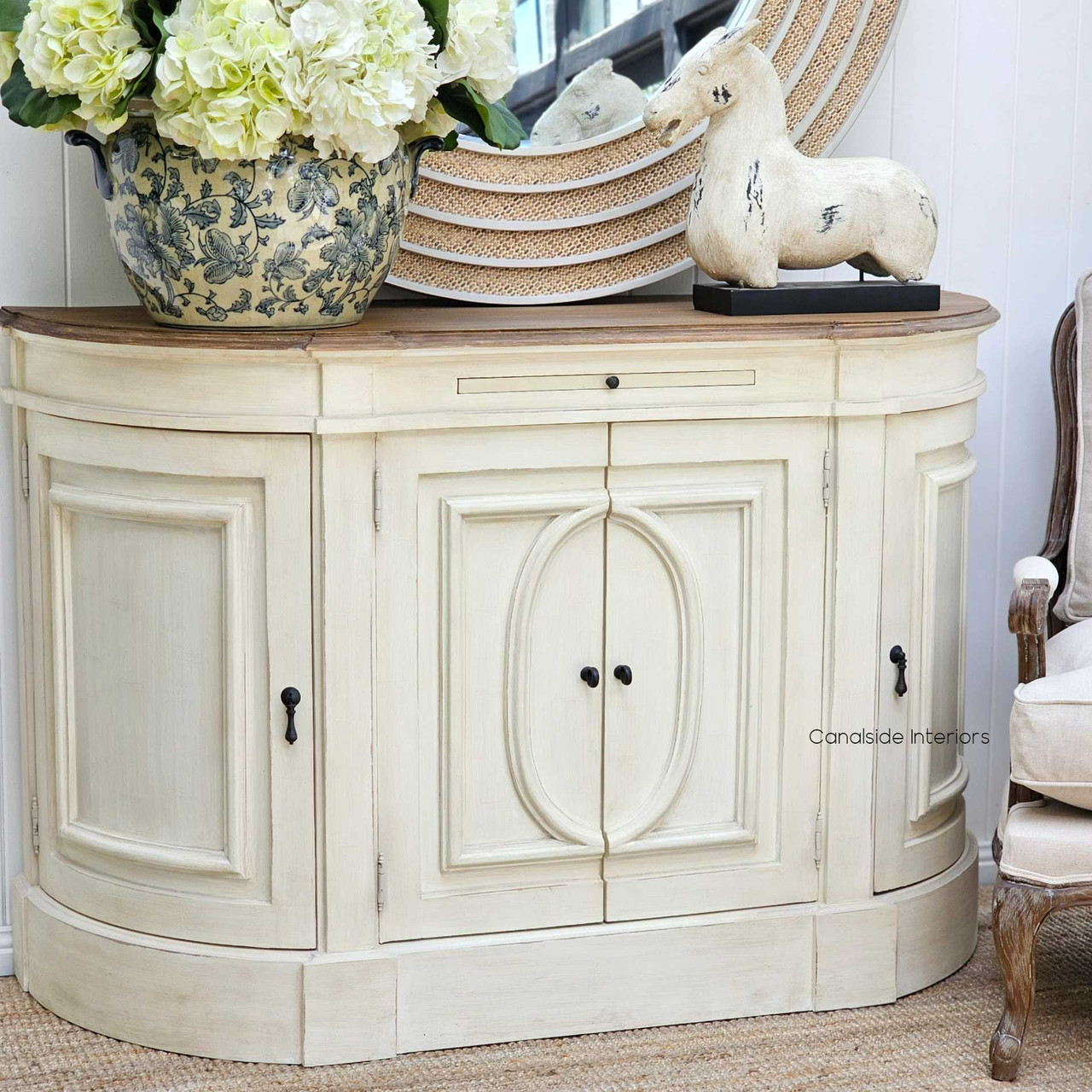 Angled view of the Bastian Sideboard, with its heavy distressing and classic silhouette, offers a chic storage solution for modern homes