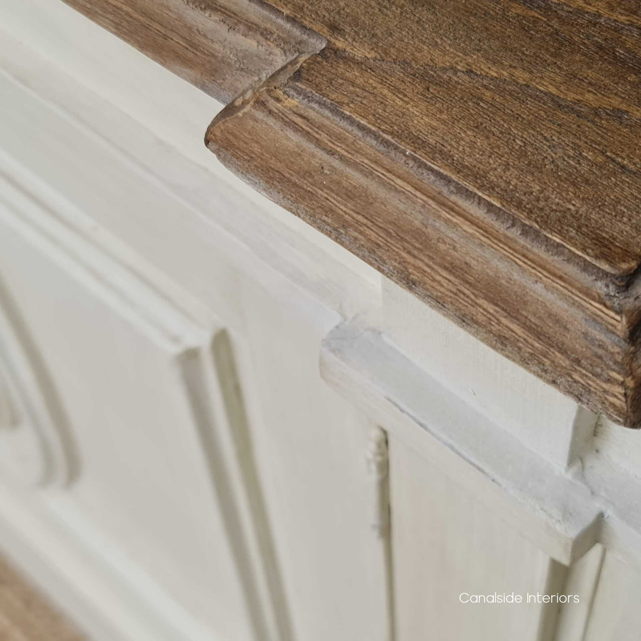 The stone finish of the Bastian Sideboard, accented with dark hardware, offers a versatile storage option that complements both Hamptons and classical decor themes