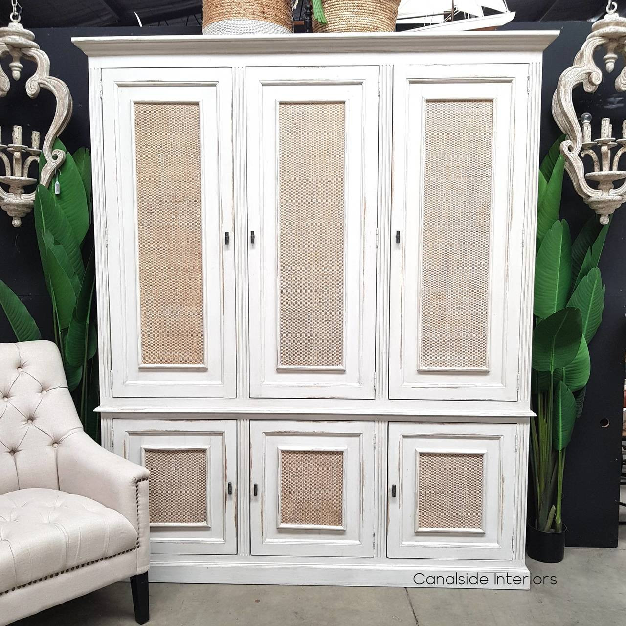 Frontal view of the Brielle Rattan Storage Cupboard at Canalside Interiors, featuring a distressed stone finish with natural washed rattan detailing.