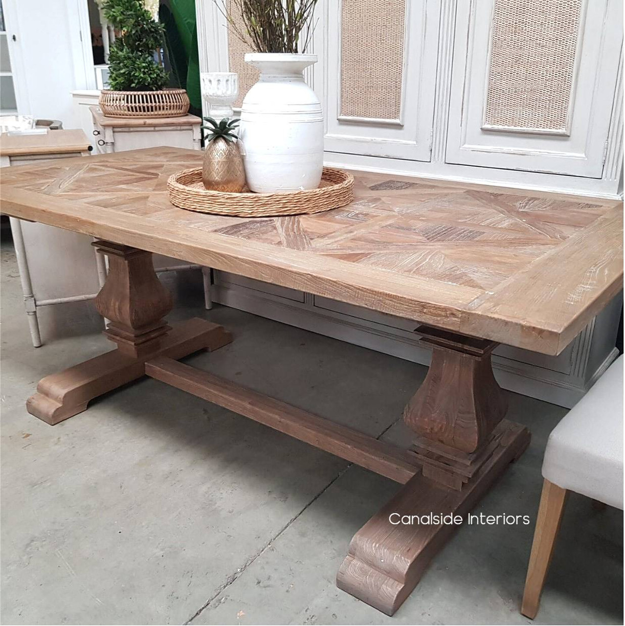 View of the Rustic Artisan Parquetry Top Dining Table, highlighting its recycled timber and elegant canon legs at Canalside Interiors.