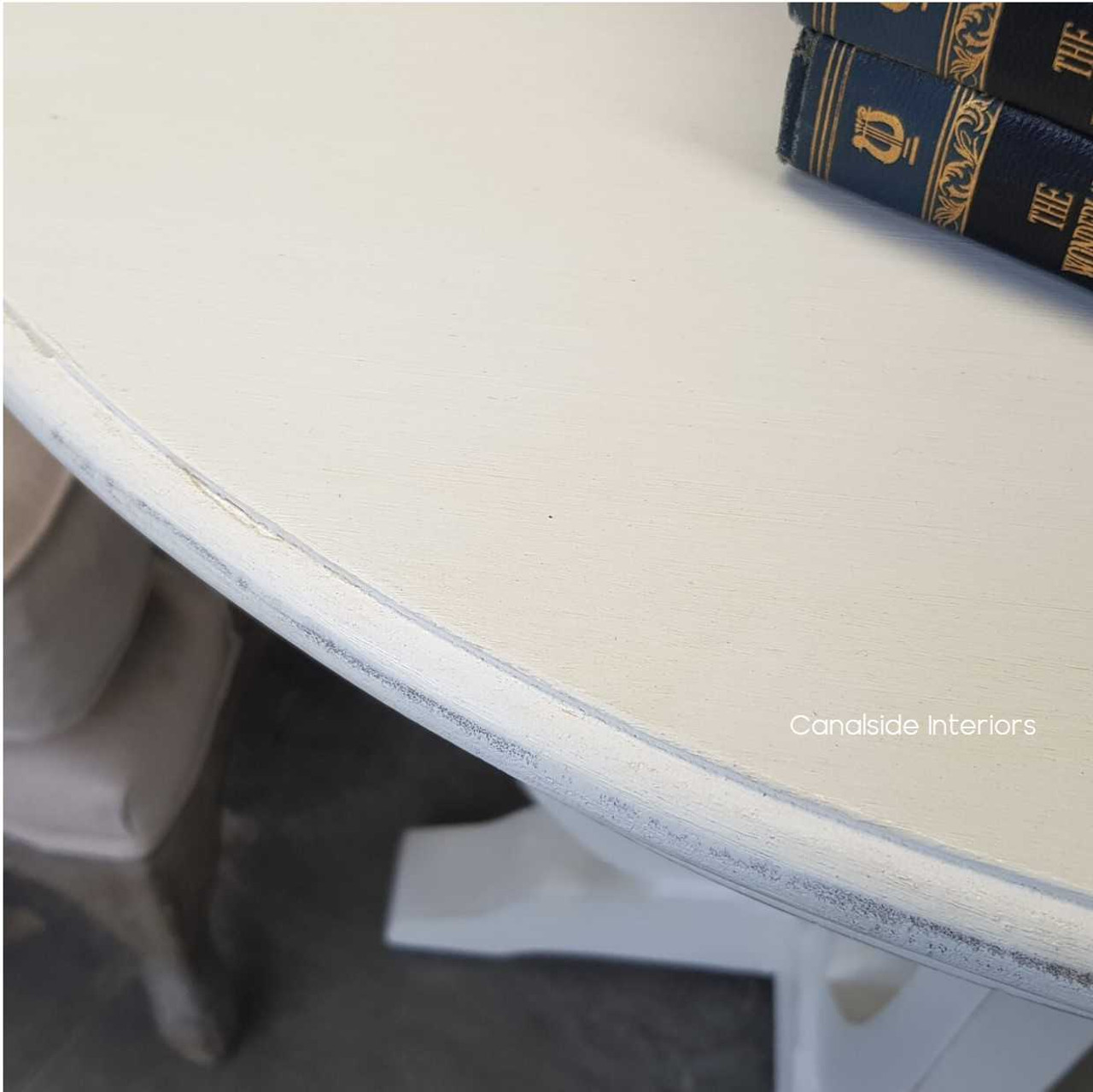 Invite timeless charm into your bedroom with Canalside Interiors' Downton Round Table, where its distressed white finish adds a breath of fresh elegance