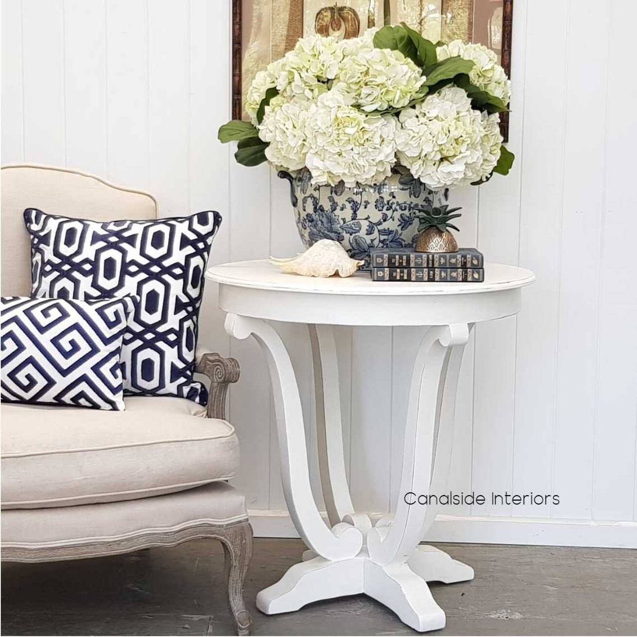 The Downton Round Hall Table in white becomes a perfect canvas for your vibrant floral arrangements or curated decor in any entryway -