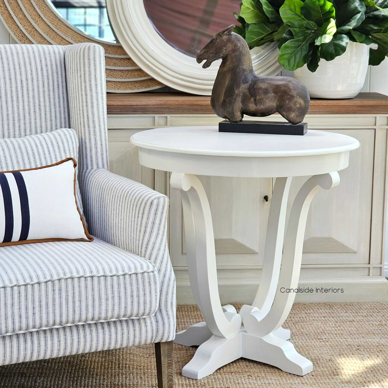 Embrace coastal charm with this Downton Round Hall Table in distressed white, perfect for adding a touch of Hamptons elegance to your entryway - Canalside Interiors.