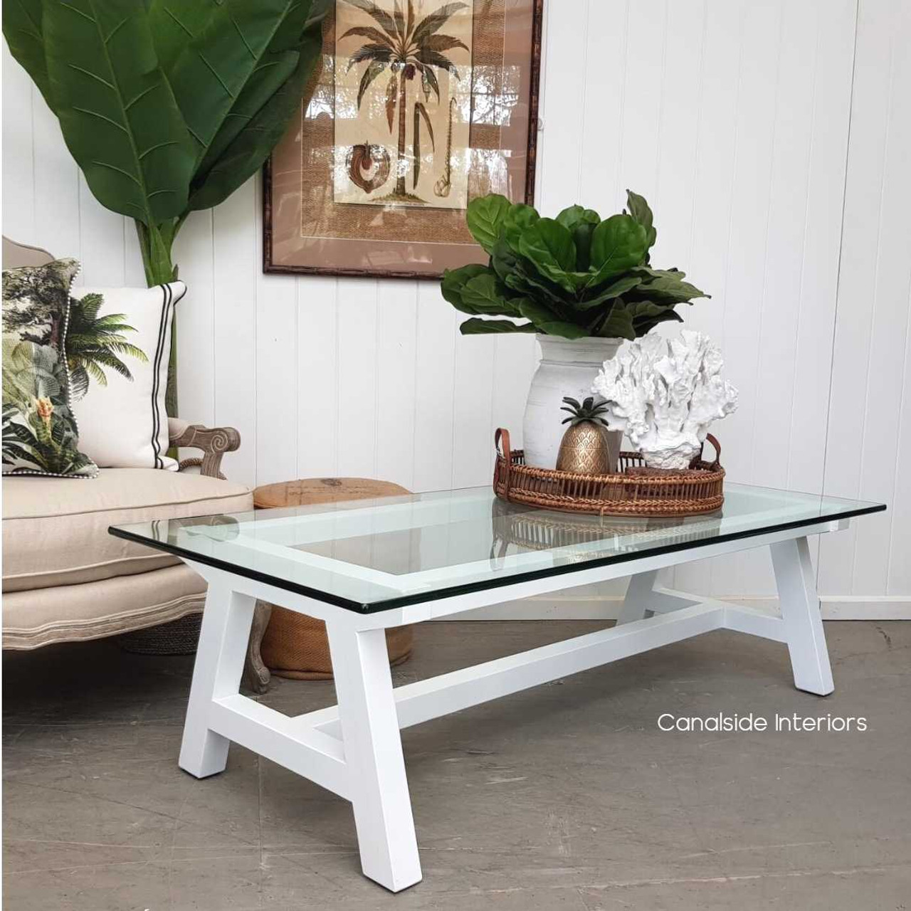 A contemporary take on classical design, this white Hamptons coffee table with glass detailing is an understated centerpiece for your living room