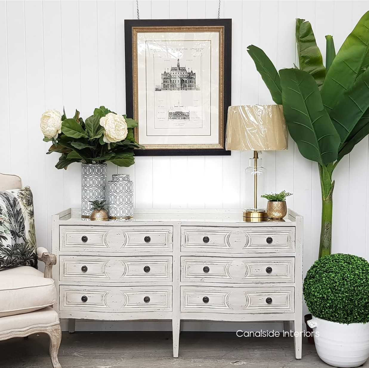 The Isobel Grande Chest's spacious drawers are wrapped in a distressed grey finish, perfect for a Hamptons-inspired dining room – Canalside Interiors.