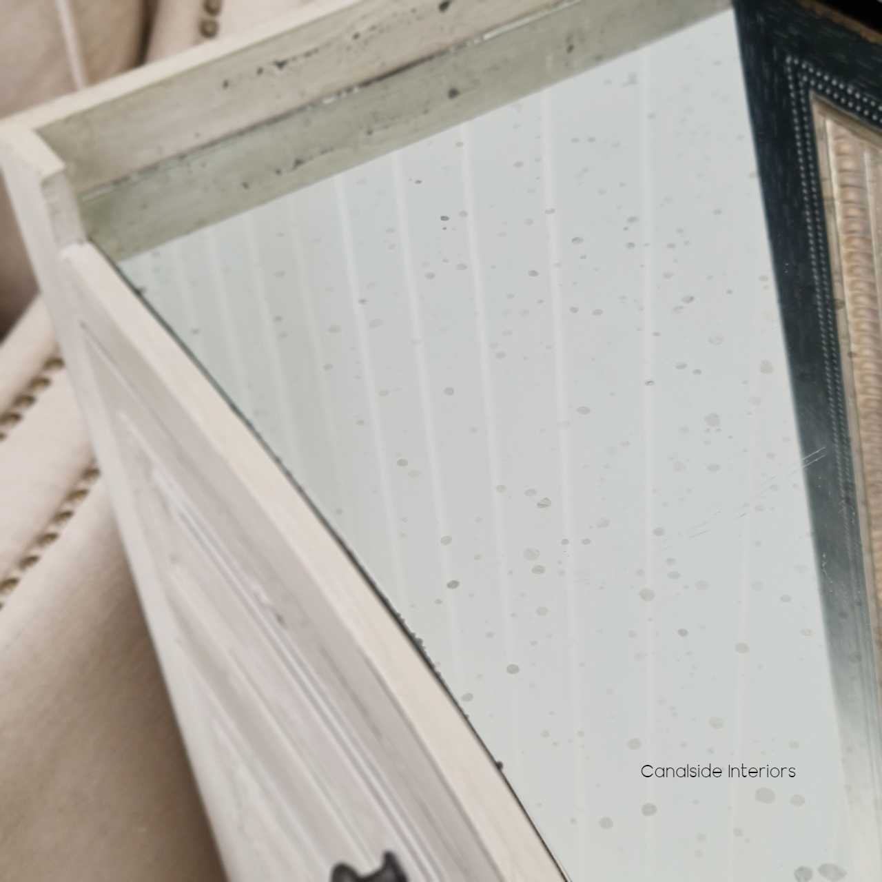 Canalside Interiors reveals the charm of the Isobel Grande Chest, featuring an antique mirrored top that enhances the distressed grey finish for a refined modern touch