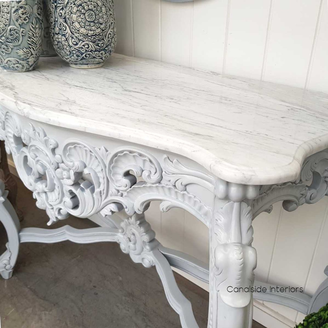 Close-up view of the grey console’s ornate carvings, manifesting the craftsmanship and quality that define Canalside Interiors' coastal furniture collection