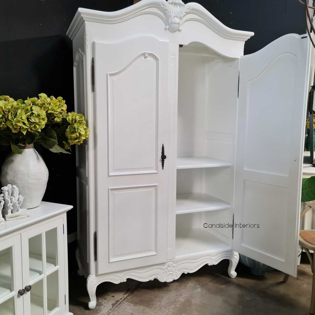 Canalside Interiors presents the James Armoire: where the allure of the Hamptons meets handcrafted, classical design in a versatile white finish