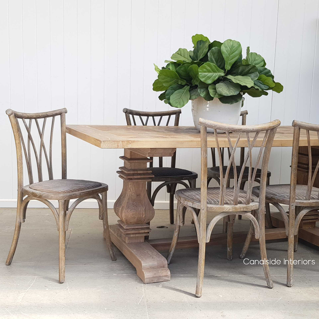 The Botanica Chair amidst a coastal Hamptons setting, showcasing its ability to complement both indoor and outdoor dining environments.