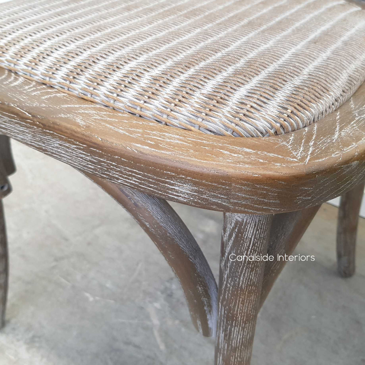 Close-up on the rattan seat of the Botanica Chair, highlighting the comfort and elegance of the slight padding and woven texture.