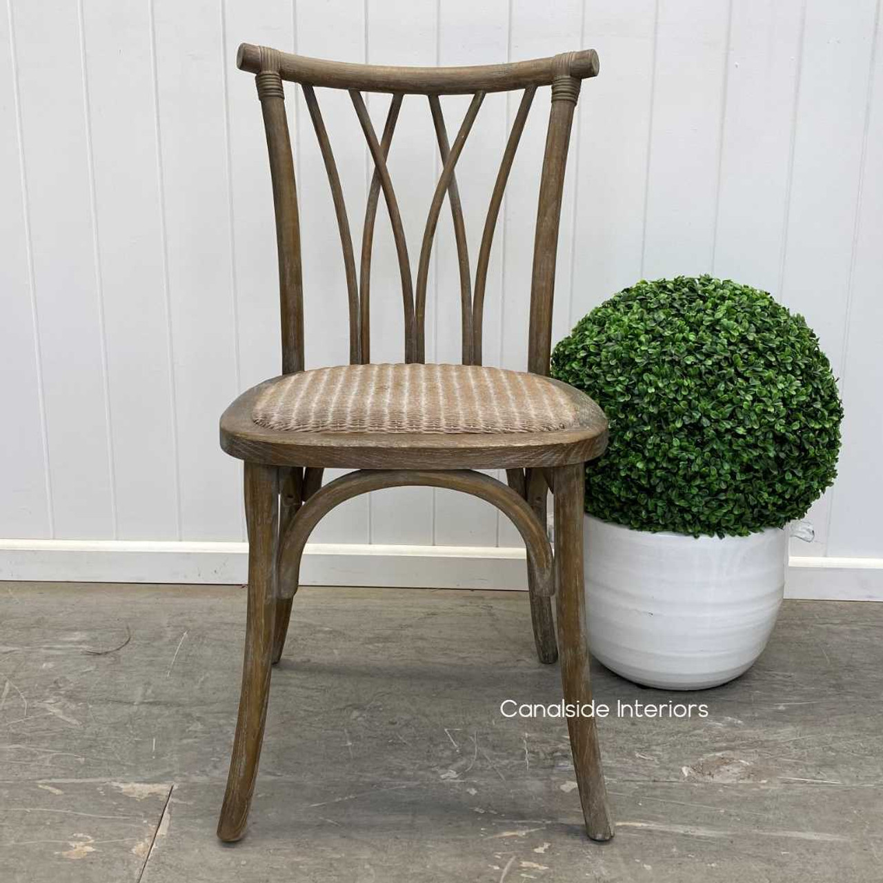 The chair captured in a well-lit dining area, showcasing its reflective quality and the timeless design that suits any home style.