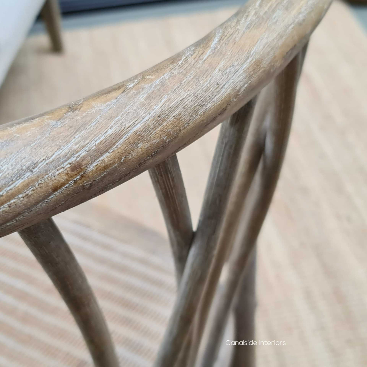 Detail shot of the chair's textured finish, emphasizing the beauty and quality of the oak timber and its easy-to-clean surface.