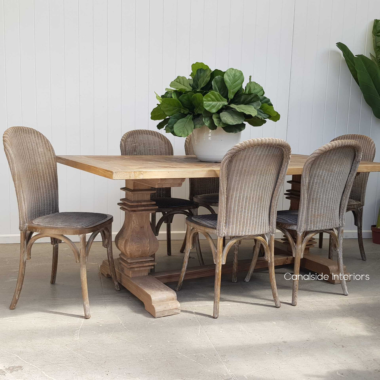 Arranged around a plantation-style dining table, enhancing the room's warm, welcoming atmosphere.