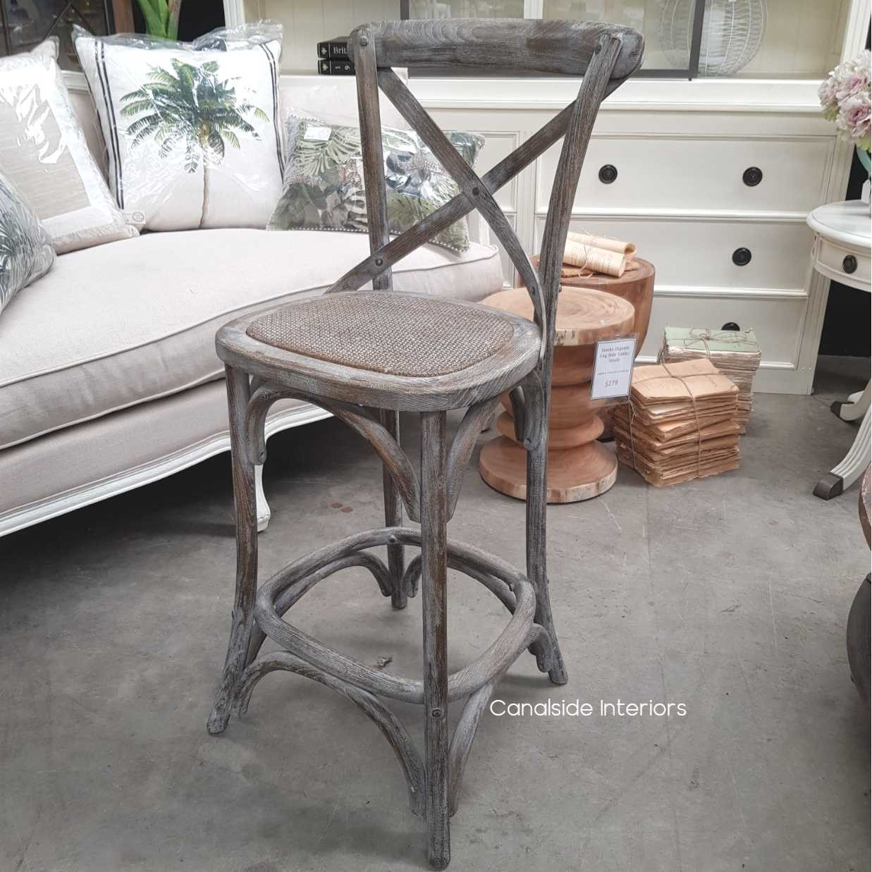Canalside Interiors' Cross Back Stool in profile, marrying distressed grey oak with Hamptons style for a chic living room addition.