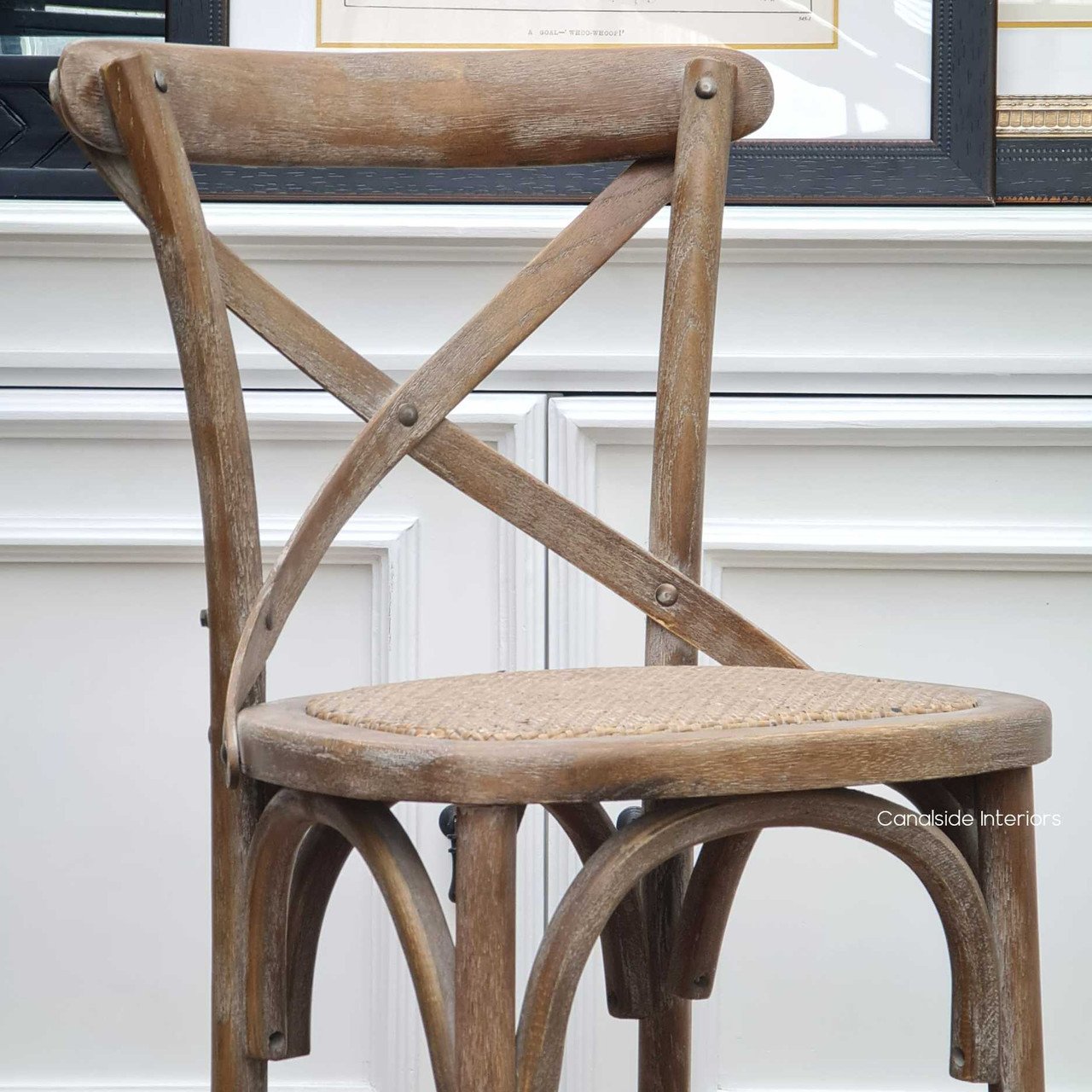 The side profile of Canalside Interiors' Cross Back Stool highlights the classical design, making it a perfect match for coastal-inspired dining rooms