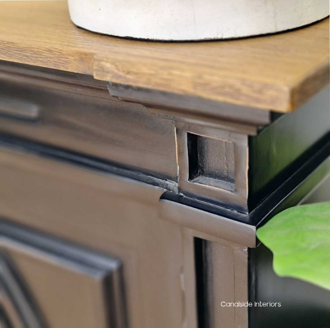 Detailed shot of the sideboard's distressed charcoal/black finish, emphasizing the artisanal craftsmanship and unique character of each piece.