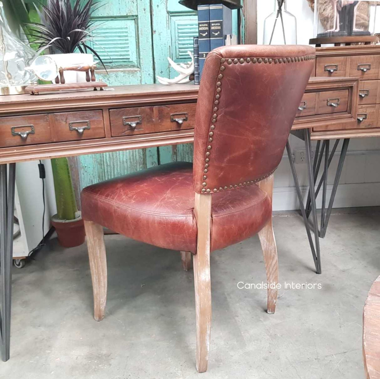 Immerse your lounge room in the timeless elegance of these Cuba Aged Leather Chairs, where traditional craftsmanship meets modern design