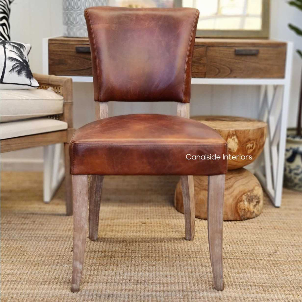 The weathered oak legs of the Cuba Dining Chair bring a coastal elegance to the luxurious waxed aged leather seating - Canalside Interiors