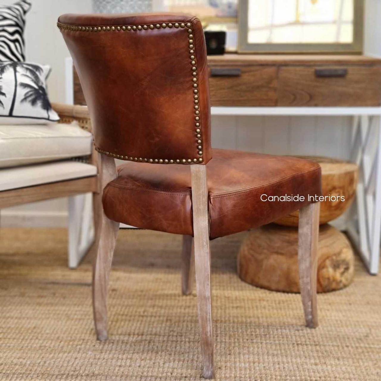 Showcasing the grandeur of Hamptons style, the Cuba Aged Leather Dining Chairs offer classical charm and modern comfort - Canalside Interiors.