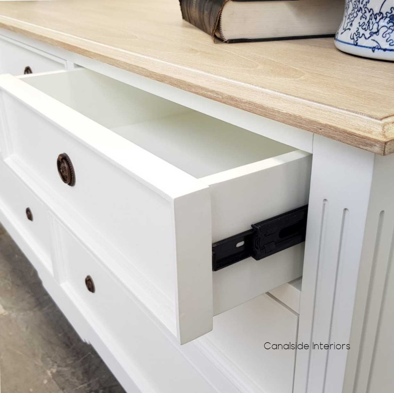 Detail of smooth metal runners on the drawers, combining functionality with the sideboard's elegant aesthetic.