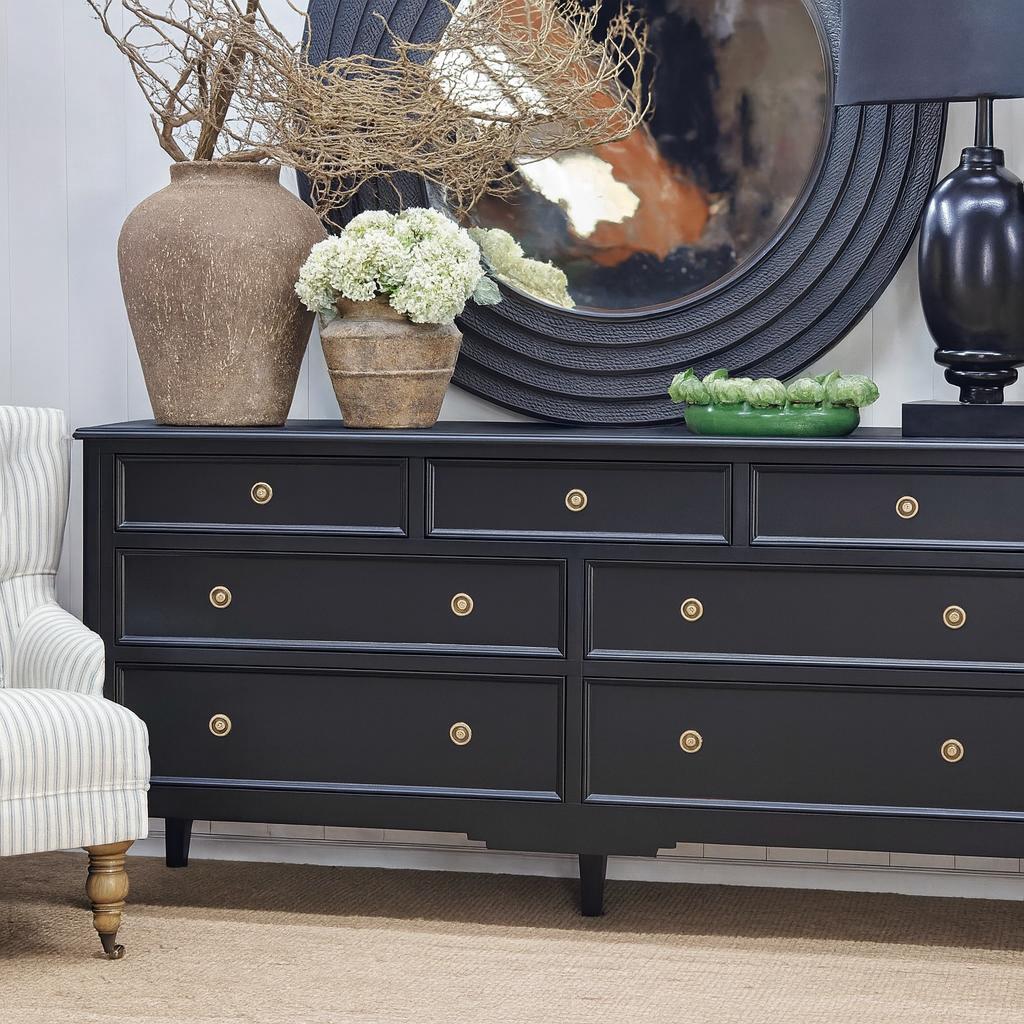 Angled shot of the black Peninsula 7 drawer chest highlighting the satin-black finish and refined proportions.