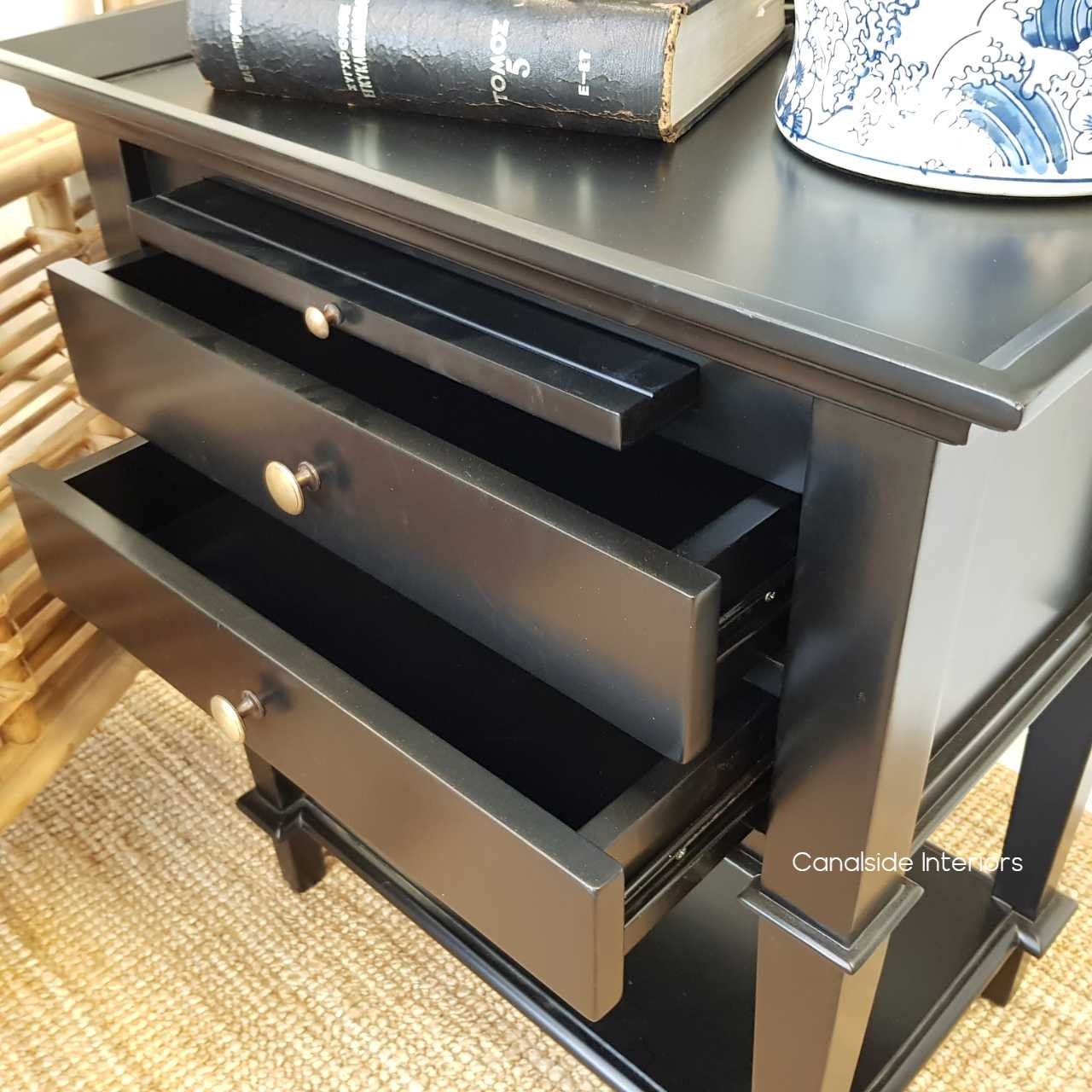 Close-up of the side table's two drawers, highlighting the quality of the metal runners for smooth functionality.