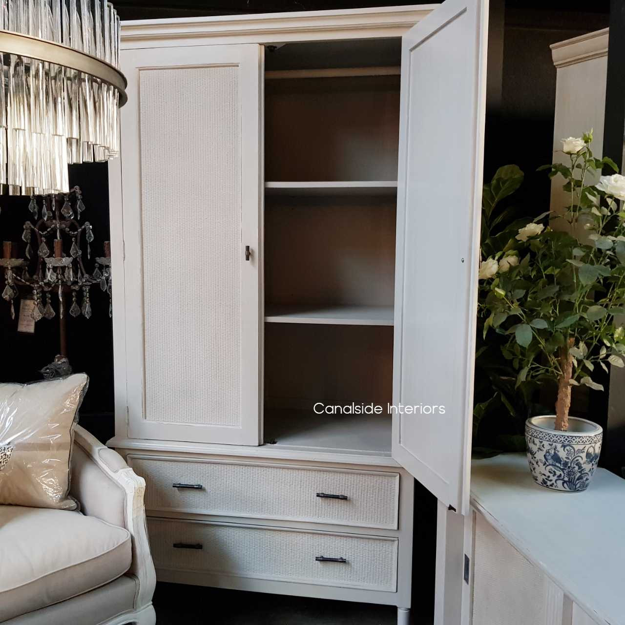 Interior view of the wardrobe, displaying the hanging rod and versatile removable shelves for organized storage.