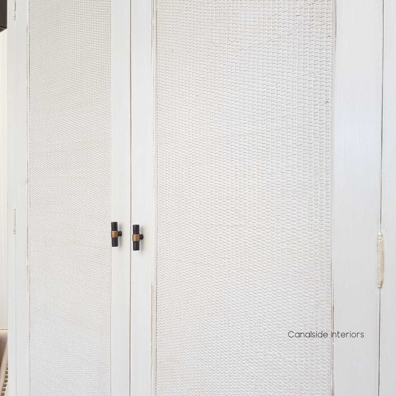 Detail shot of the distressed stone finish, emphasizing the wardrobe's unique texture and elegant appearance.