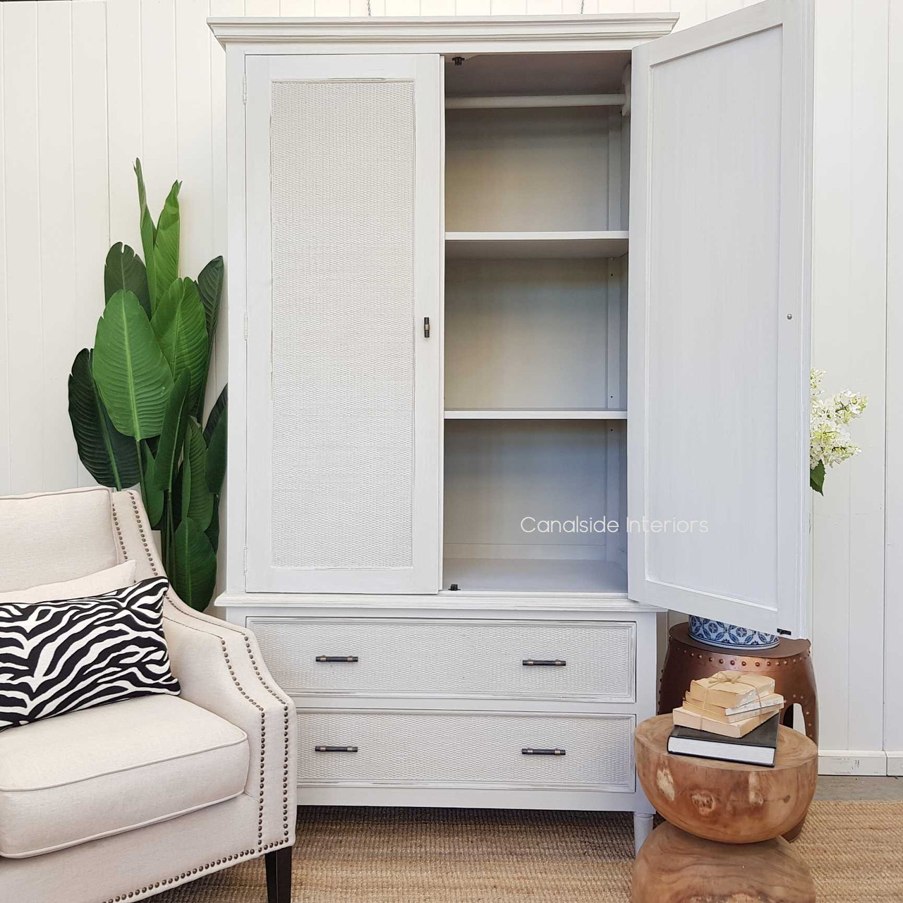 Natural lighting accentuating the texture and color variations of the stone rattan, enhancing the wardrobe's aesthetic appeal.