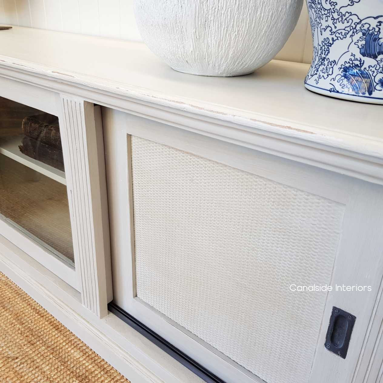 Detail of the unit's natural rattan in a distressed finish, showcasing the artisanal charm and quality craftsmanship.