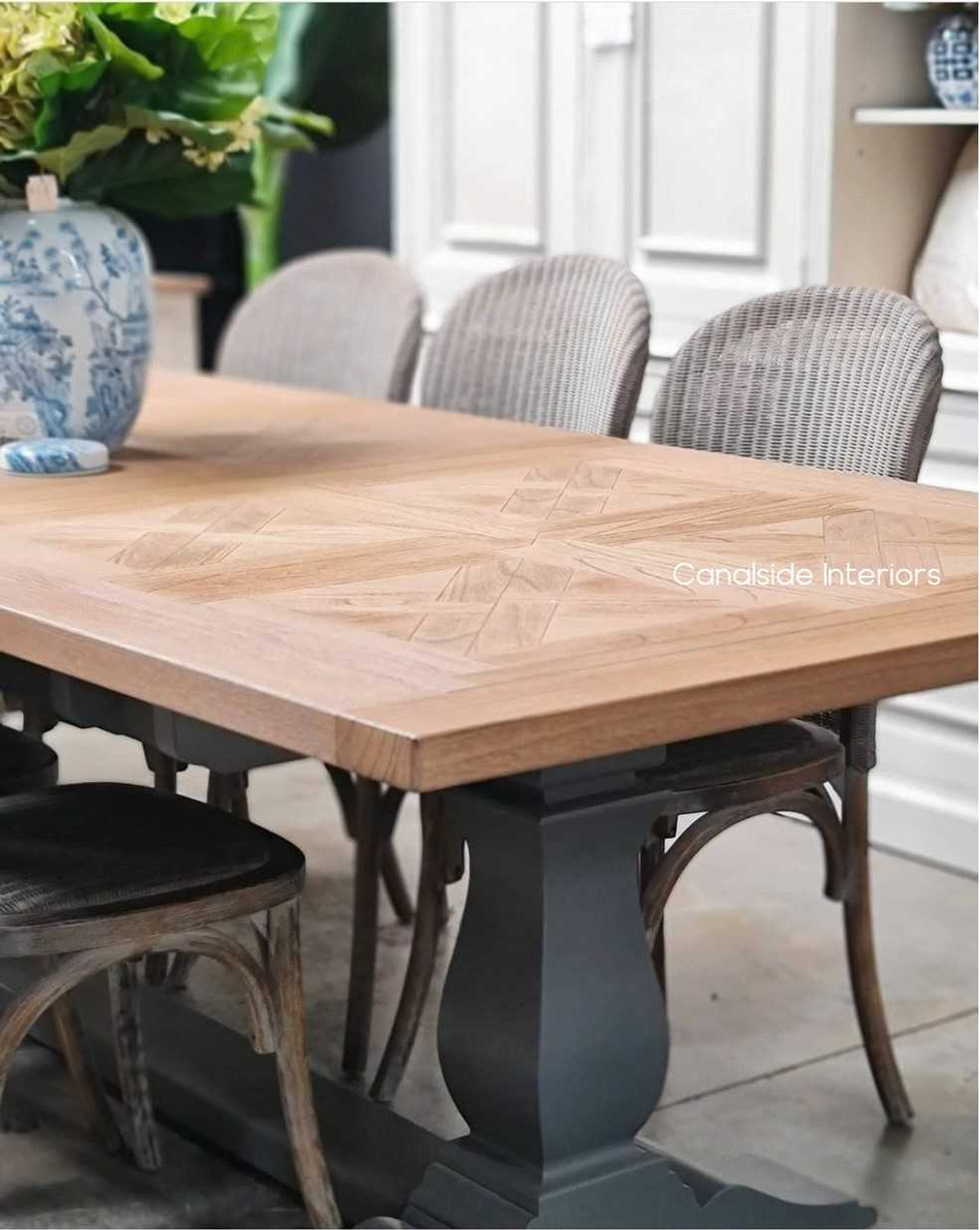 Side view of the Balmoral table, partially extended, revealing the seamless mechanism and the elegant lines of the distressed grey base